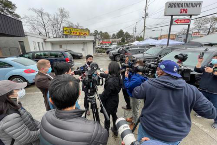 Atlanta-based CNN correspondent Natasha Chen (center, black coat) reports as Georgia Rep. Sam Park makes remarks at one of the sites of the March 16 mass shooting at three Asian-owned massage businesses. 