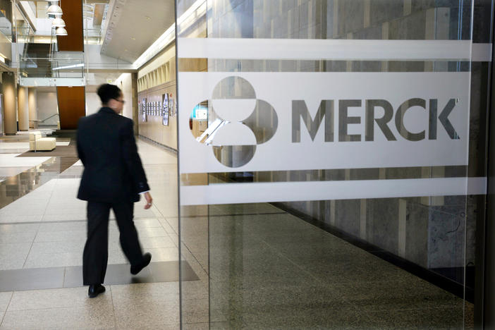 FILE - In this Dec. 18, 2014, file photo, a person walks through a Merck company building, in Kenilworth, N.J.