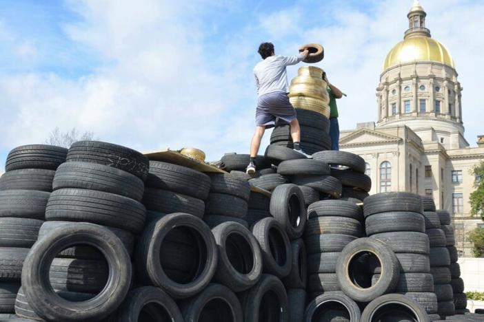 Old tires stacked in front of the Georgia State Capitol