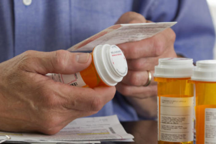 Person holding prescription drug bottle