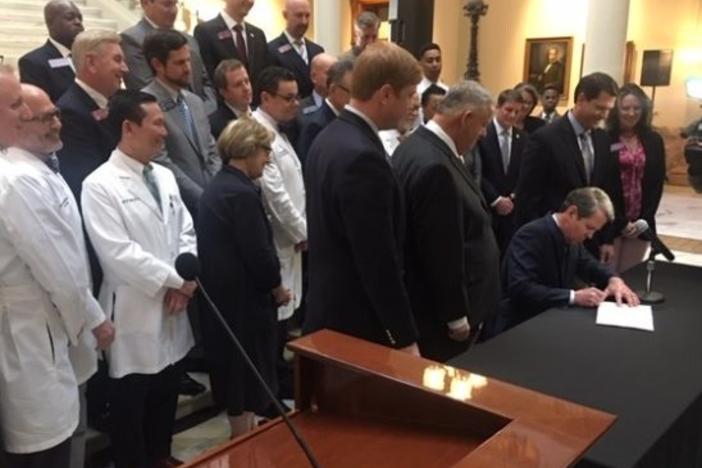 Kemp signing a bill