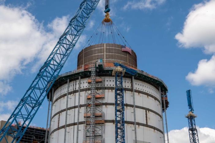 A 720,000-pound water tank is placed atop the Unit 4 containment vessel at Plant Vogtle.