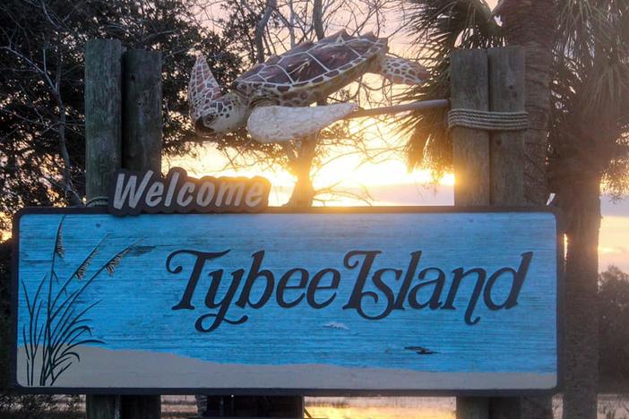 Welcome to Tybee Island sign, with the sun behind it