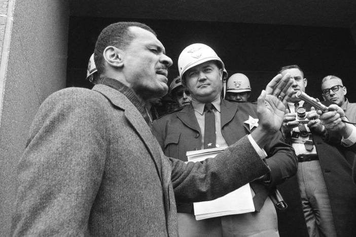 A young C.T. Vivian preaches in front of a sheriff officer in this black and white photo from 