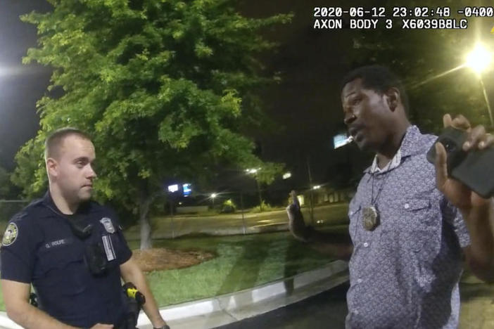 In this June 12, 2020 file photo from a screen grab taken from body camera video provided by the Atlanta Police Department Rayshard Brooks speaks with Officer Garrett Rolfe in the parking lot of a Wendy's restaurant, in Atlanta.