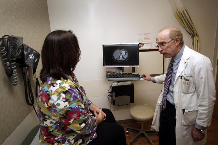 Dr. Paul J. Pockros, head, Division of Gastroenterology/ Hepatology and director, Liver Disease Center, talks with patient Loretta Roberts as they view her liver on a computer screen in his exam room at Scripps Green Hospital in San Diego, in this photo taken Jan. 13, 2011.