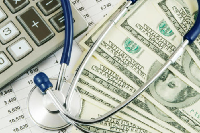 Photo of stethoscope, money and calculator