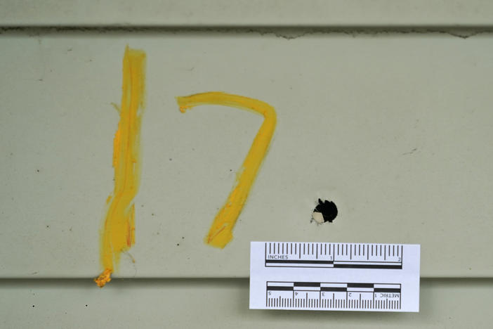 A bullet hole marked by police is shown Monday, June 7, 2021, at a house where seven people were shot Sunday night, in Cleveland. 