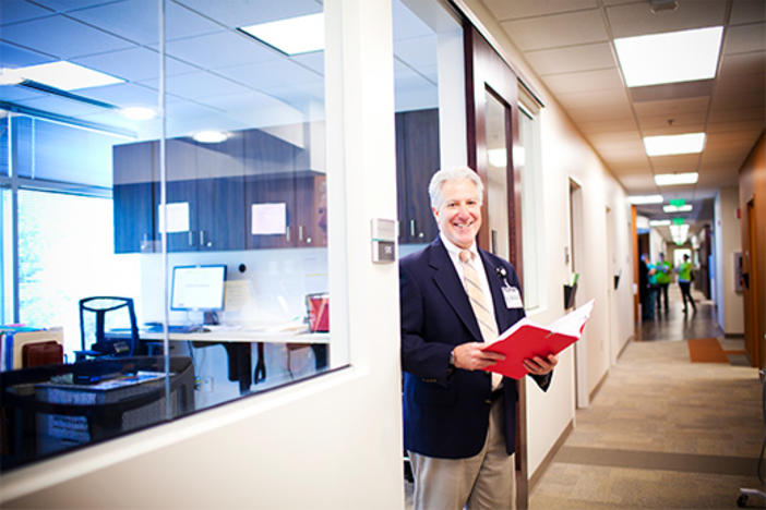 Dr. Allan Levey stands in the doorway of an office.