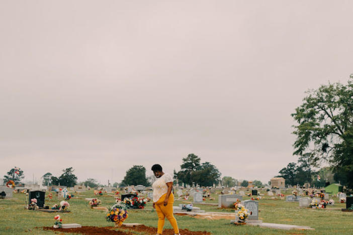 Latasha Taylor visits the cemetery where her mother, uncle, and aunt are buried, in Dawson, Ga. All three died of COVID-19 in 2020.