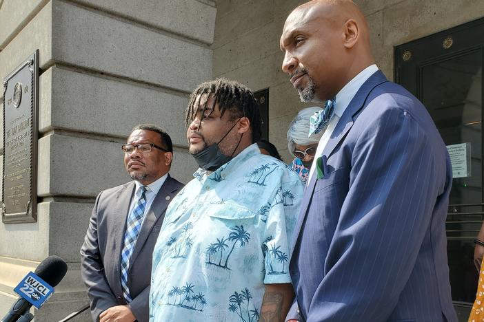 three men address reporters in front of Savannah city hall