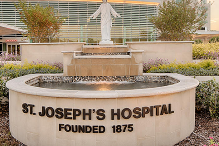 statue, fountain, and sign outside St. Joseph's Hospital in Savannah