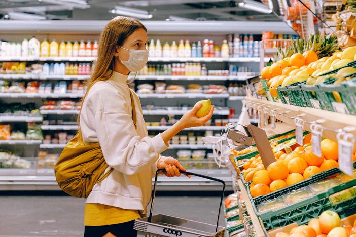 Woman in grocery store wearing mask