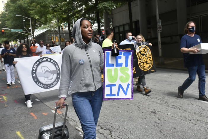 Klaire Gumbs, an organizer with the New Georgia Project, marches to the Georgia Department of Labor headquarters in Atlanta.