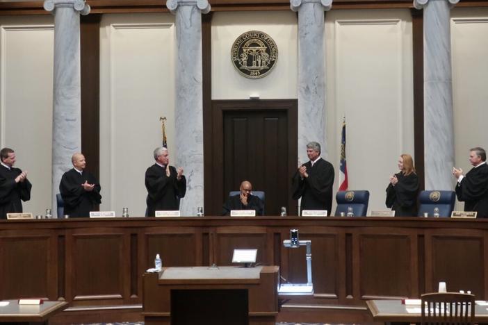 Georgia Supreme Court justices applaud outgoing Chief Justice Harold Melton as he presides over his final oral arguments on June 9, the first day the courtroom reopened for in-person proceedings since March 2020. Melton's resignation effective July 1 allows Gov. Brian Kemp his third opportunity to reshape the court. Stanley Dunlap/Georgia Recorder