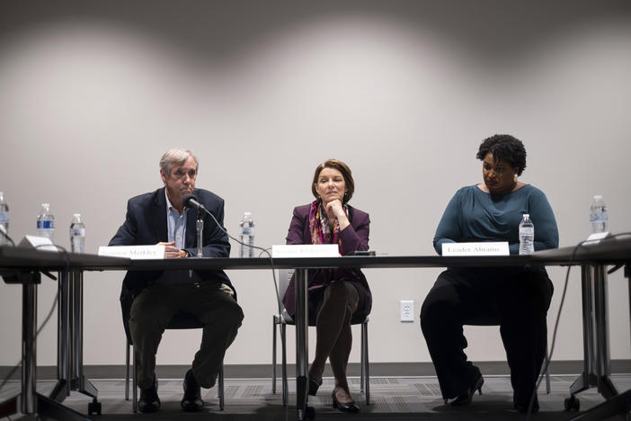 Sen. Jeff Merkley, D-Ore., from left, Sen. Amy Klobuchar, D-Minn., and former Georgia State Rep. Stacey Abrams listen to voters during a roundtable in Smyrna, Ga., on Sunday, July 18, 2021. 