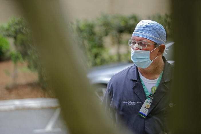 Chaplain Will Runyon waits outside of Phoebe Putney Memorial Hospital in Albany, Ga., on Monday, April 20, 2020. 