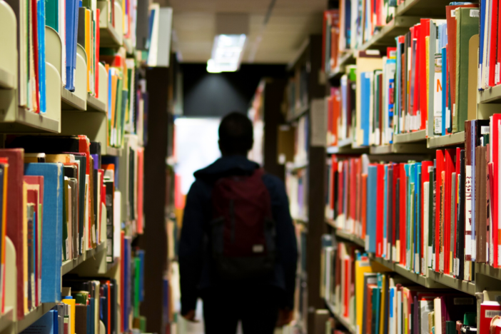 A student walks through a library.