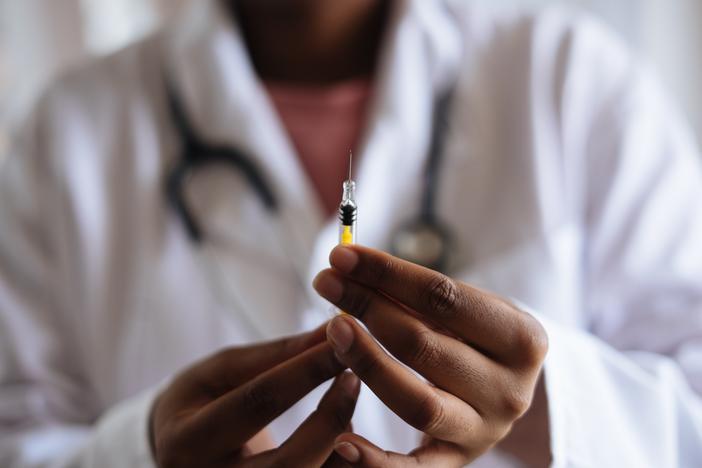 person holding syringe
