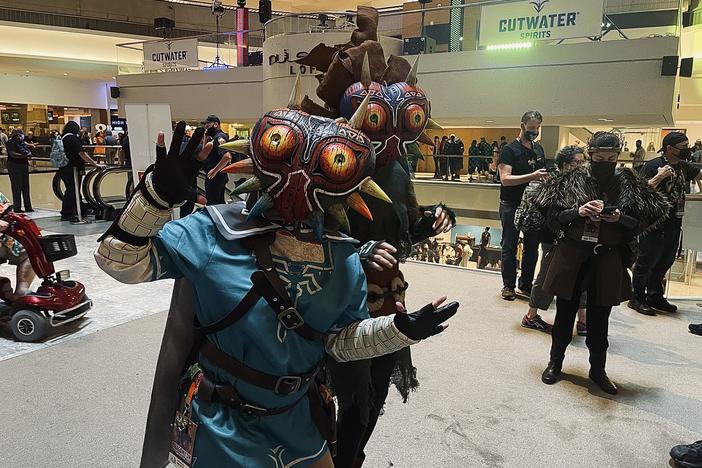 Two cosplayers pose at the Marriott Marquis at Dragon Con 2021. This year's convention was marked by COVID-19 safety precautions and precautions, as well as an attendance cap – due to the surging delta variant across the state. 