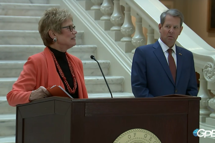 DPH Commissioner Dr. Kathleen Toomey and Gov. Brian Kemp stand at a podium in the Georgia Capitol Sept. 30, 2021.