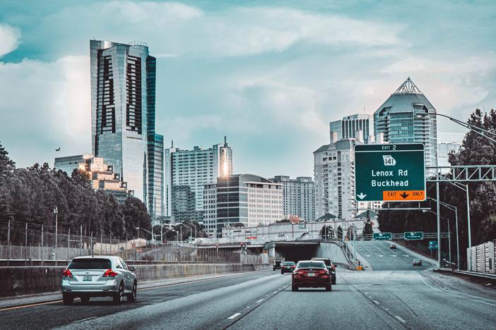 Cars on Road Near City Buildings