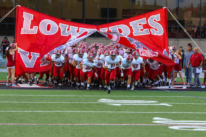 Lowndes Football Team breaks through banner