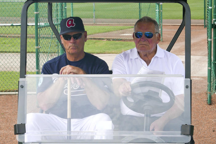 Current Braves manager Brian Snitker with former Manager Bobby Cox in golf cart