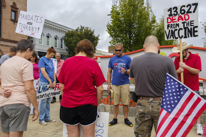 Prayer before an anti-vaccine protest in Macon in August. 