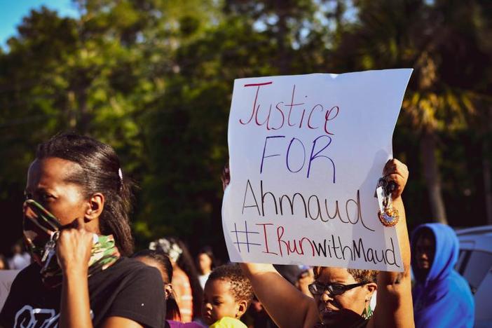 A protestor holds up a sign at a protest.