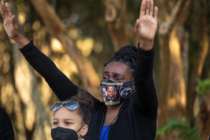 Ahmaud Arbery’s aunt Carla Arbery prays during a vigil outside of the Glynn County Courthouse in Brunswick on Oct. 17, 2021.