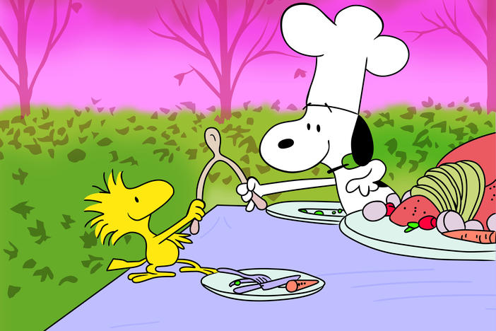 Woodstock and Snoopy breaking a wishbone.