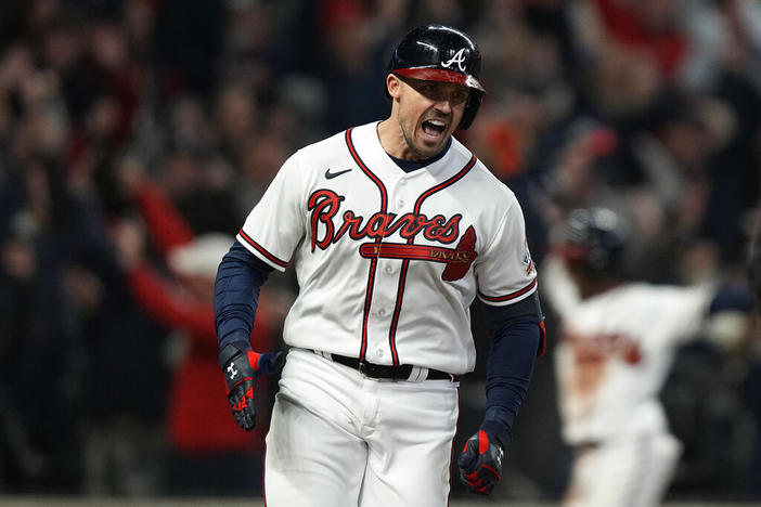 Atlanta Braves' Adam Duvall celebrates after his grand slam home run during the first inning in Game 5 of baseball's World Series between the Houston Astros and the Atlanta Braves Sunday, Oct. 31, 2021, in Atlanta.