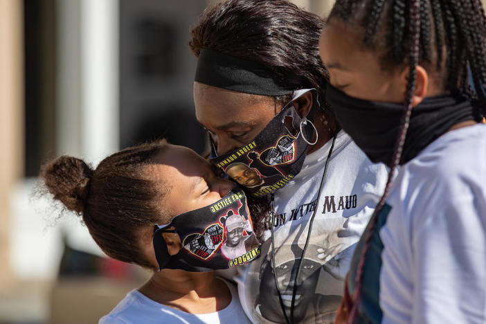 Ahmaud Arbery’s aunt Carla Arbery comforts Aailyah Trimmings, 9, and Alyria Carter, 10, outside of the Glynn County Courthouse in Brunswick on Oct. 16.