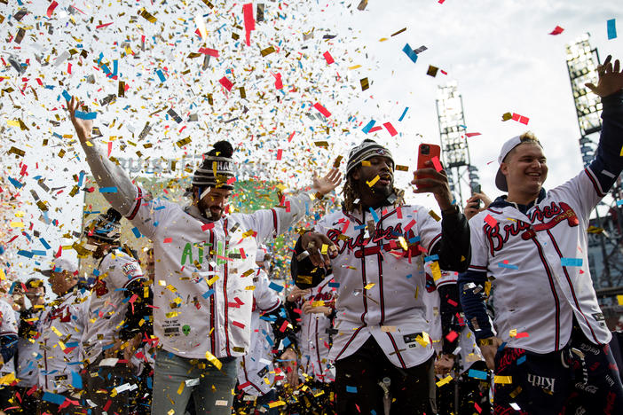 Braves players Dansby Swanson, Touki Tousaaint and Joc Pederson cheer under a shower of confetti during the team’s celebration at Trusit Park on Nov. 5.