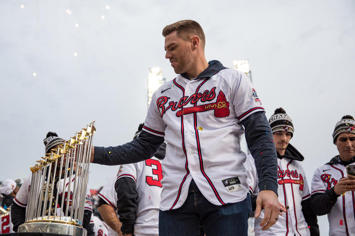 Braves first baseman Freddie Freeman admires The Commissioner's Trophy during the team’s victory celebration at Truist Park on Nov. 5.