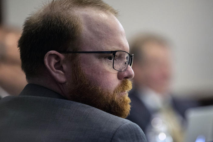 Travis McMichael sits with his attorneys before the start of closing arguments to the jury during the trial of he, and his father Greg McMichael, and William "Roddie" Bryan, at the Glynn County Courthouse, Monday, Nov. 22, 2021, in Brunswick, Ga.