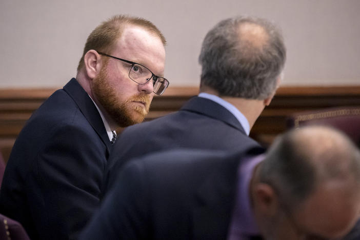 Travis McMichael listens to his attorney Robert Rubin before the start of his trial in the Glynn County Courthouse, Tuesday, Nov. 9, 2021, in Brunswick, Ga.
