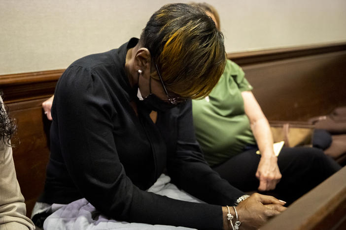 Ahmaud Arbery's mother Wanda Cooper-Jones reacts to autopsy photos entered into evidence during the trial of Greg McMichael and his son, Travis McMichael, and a neighbor, William "Roddie" Bryan in the Glynn County Courthouse, Tuesday, Nov. 16, 2021, in Brunswick, Ga.