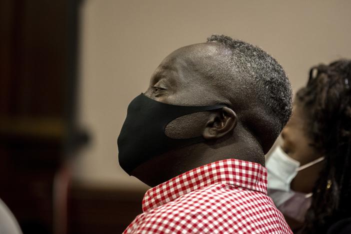  Marcus Arbery, center, father of Ahmaud Arbery, listens during the jury selection for the trial of Greg and Travis McMichael and their neighbor, William "Roddie" Bryan, at the Glynn County Courthouse, Monday, Oct. 25, 2021, in Brunswick, Ga.