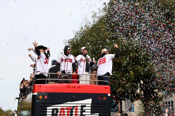 Some of the Atlanta Braves players celebrate on top of a double decker bus during the parade.