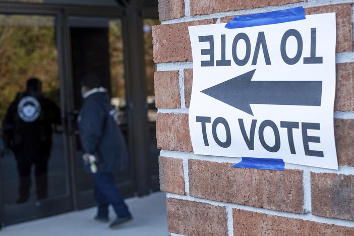 A voter enters Jackson Memorial Baptist Church to cast her vote during municipal elections in Atlanta on Tuesday, Nov. 2, 2021. 