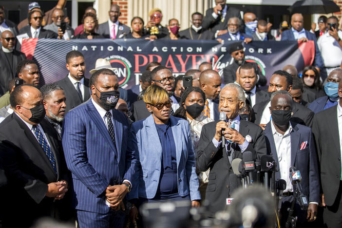 The Rev. Al Sharpton, second from right, flanked by Ahmaud Arbery's parents, Wanda Cooper-Jones, left, and Marcus Arbery, right, speaks to over nearly 750 pastors, supporters and family of Ahmaud Arbery gathered outside the Glynn County Courthouse during a Wall of Prayer event, Thursday, Nov. 18, 2021, in Brunswick, Ga. 