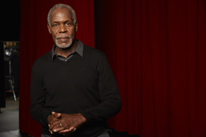 Actor Danny Glover stands backstage. 