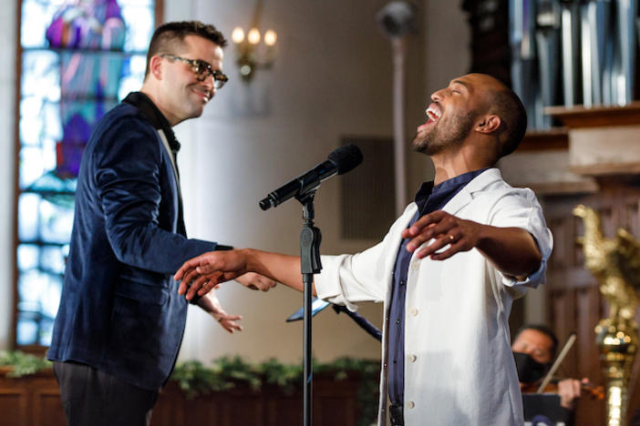 A conductor and singer in a church.