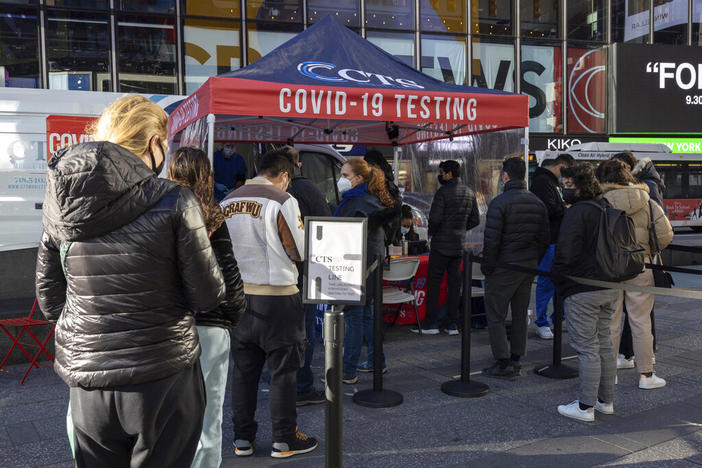 People wait in line at COVID-19 testing site in Times Square on Friday, Dec. 3, 2021, in New York. The omicron variant of COVID-19, which had been undetected in the U.S. before the middle of last week, had been discovered in at least five states by the end of Thursday, showing yet again how mutations of the virus can circumnavigate the globe with speed and ease.