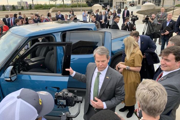  Gov. Brian Kemp steps out of a Rivian truck Thursday at a press event announcing the the electric vehicle maker will build a factory in Georgia. Jill Nolin/Georgia Recorder