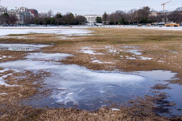 A year after the attack on the U.S. Capitol, the Ellipse near the White House where President Donald Trump spoke is covered with slush from a recent snowstorm, Thursday, Jan. 6, 2022, in Washington. Thursday marks the first anniversary of the Capitol insurrection, a violent attack that has fundamentally changed Congress and prompted widespread concerns about the future of American democracy. 