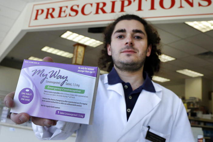 Pharmacist holds box of Plan B medication