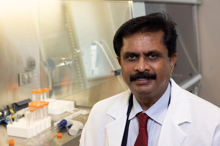 Anumantha Kanthasamy wears white lab coat in a laboratory.